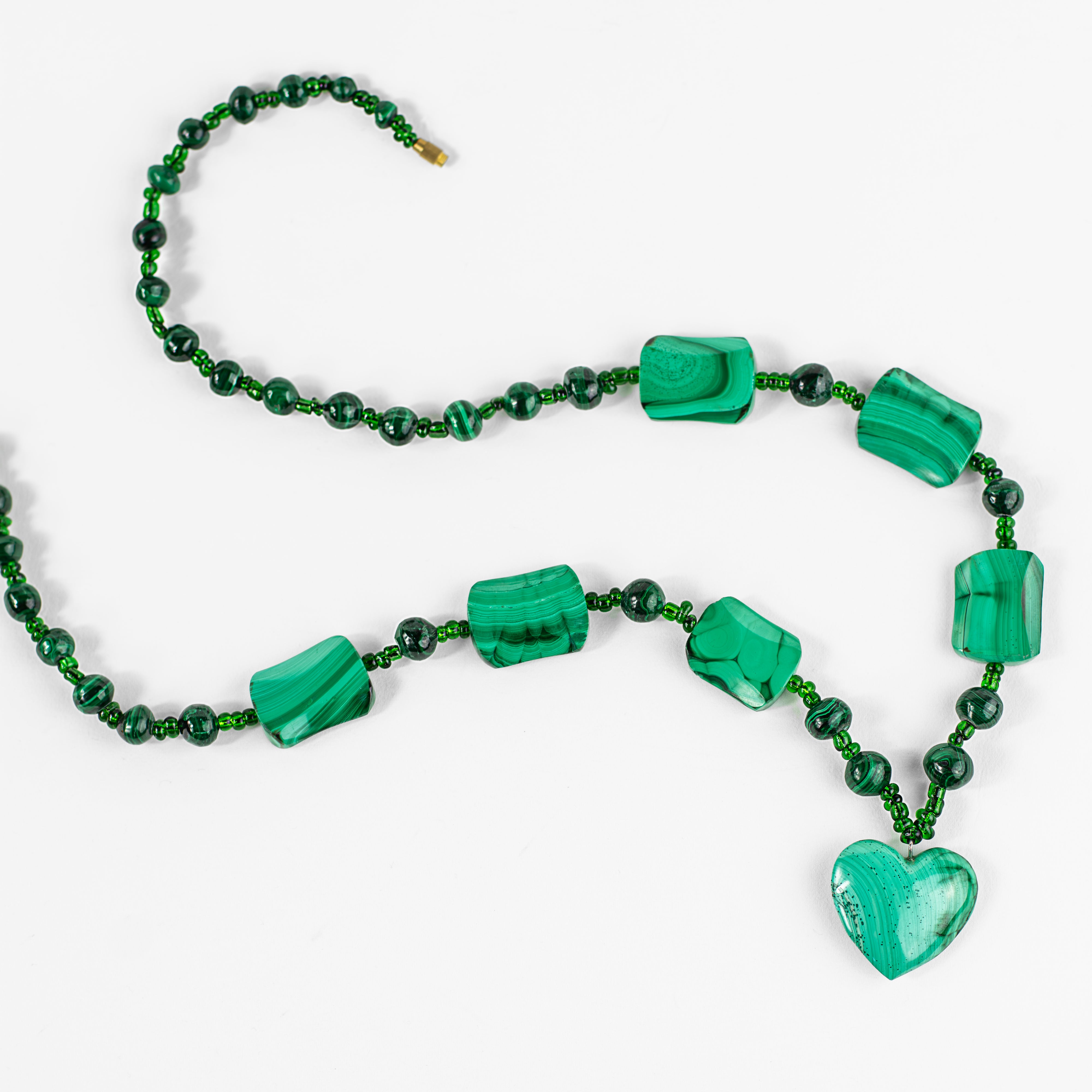 picture of a beautiful green jeweled necklace with a heart shaped pendant