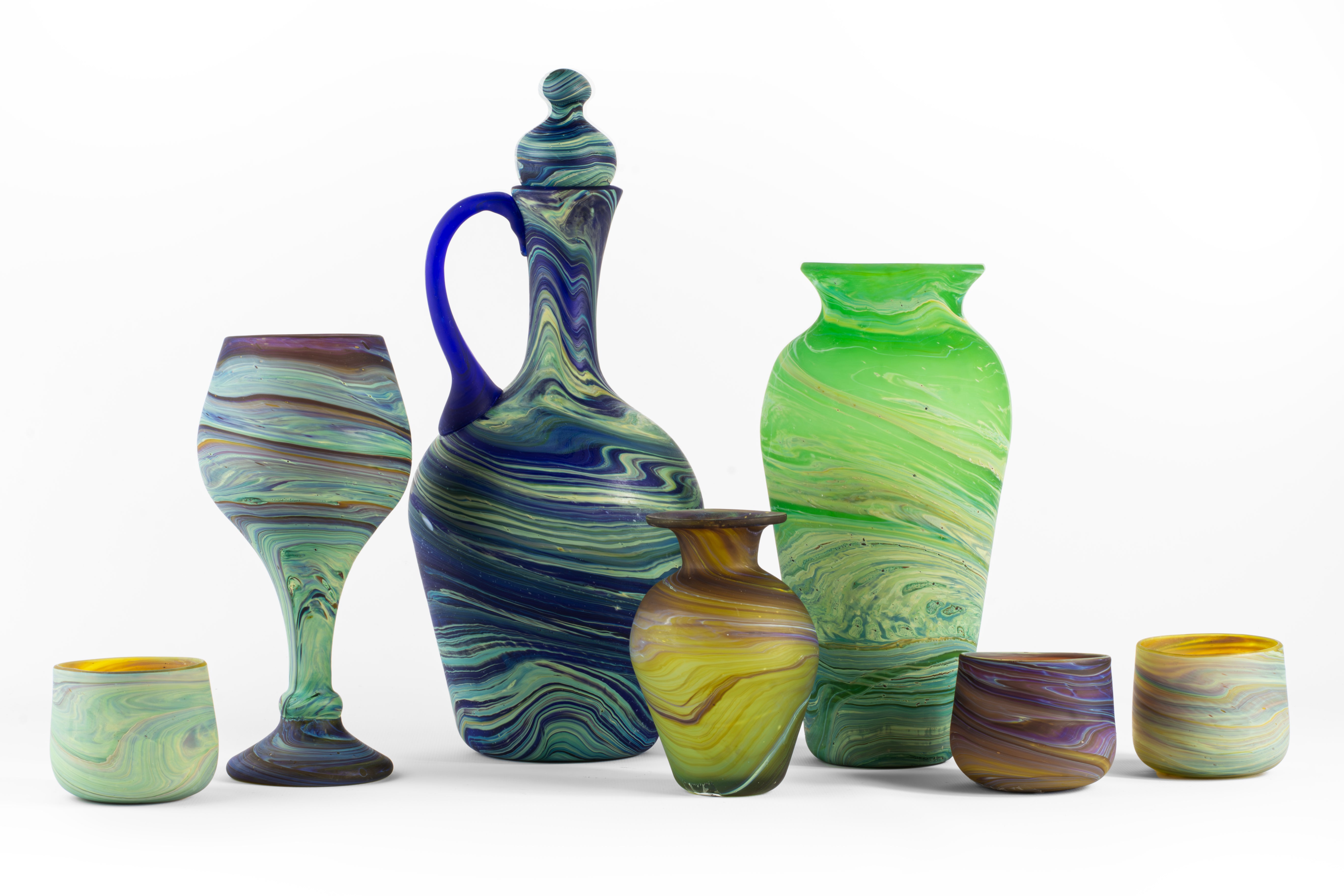 a collection of colorful glass cups and containers